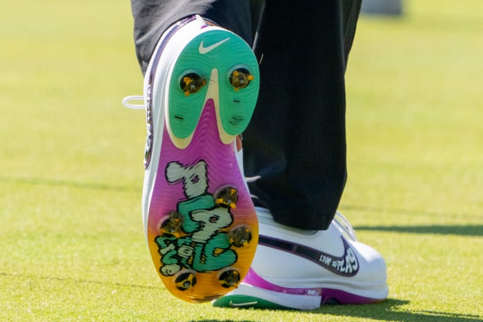 View of Rory McIlroy's white, green, and purple Nike golf shoes.
